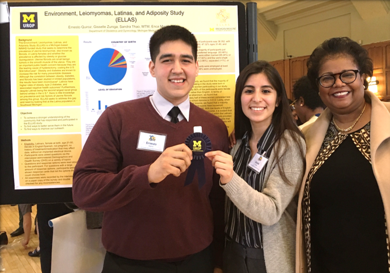 Ernesto Quiroz, Gisselle Zuniga, and Dr. Erica Marsh pose in front of a poster at the UROP symposium.